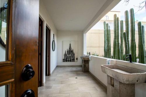 a bathroom with a sink and cactuses at Modern loft with luxury amenities in San Miguel in San Miguel de Allende