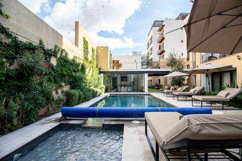 a swimming pool with blue pads in a building at Modern loft with luxury amenities in San Miguel in San Miguel de Allende