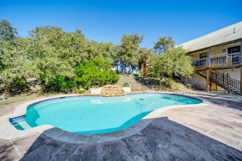 a swimming pool in the middle of a yard at 5 Mi to Dtwn Dripping Springs Cabin with Jacuzzi! in Dripping Springs