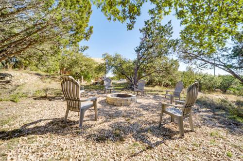 a group of chairs sitting around a fire pit at 5 Mi to Dtwn Dripping Springs Cabin with Jacuzzi! in Dripping Springs
