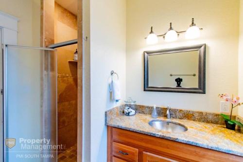 a bathroom with a sink and a shower at Can't Buy Me Love - U of Tampa Flat in N Hyde Park in Tampa