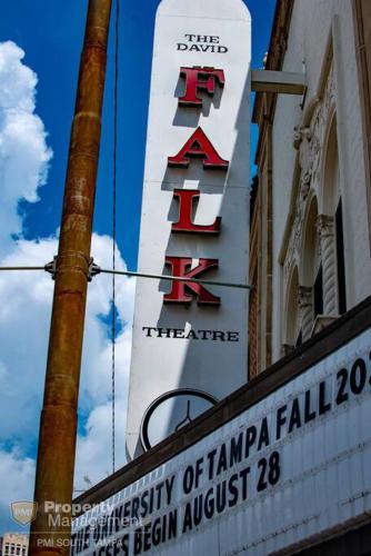 a sign for a theatre on the side of a building at Can't Buy Me Love - U of Tampa Flat in N Hyde Park in Tampa