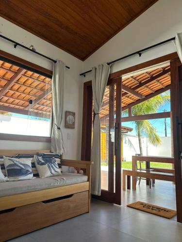 a bedroom with a bed and sliding glass doors at Casa Jubarte in Alcobaça