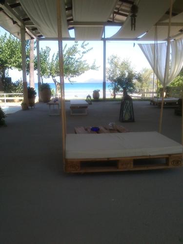 a bed in a pavilion with a view of the ocean at Evoikos beach & resort in Livanátai