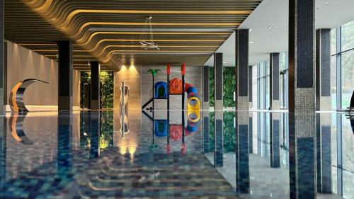 a lobby with a swimming pool in a building at Hotel Mazurski Raj in Ruciane-Nida