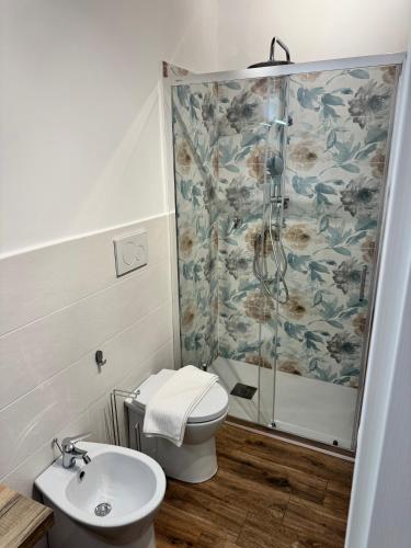 a bathroom with a shower and a toilet and a sink at La Terrazza di Cirico' in Carlentini