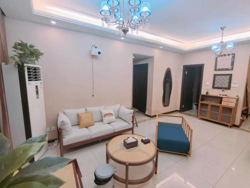a living room with a couch and a table at Mist Nest Apartment in Chongqing