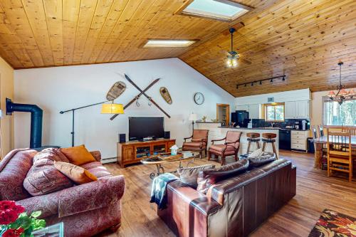 a living room with two couches and a kitchen at Ollie's Place in Breckenridge