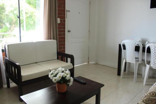 a living room with a chair and a coffee table at Hotel & Resort Villa del Sol in Tumaco