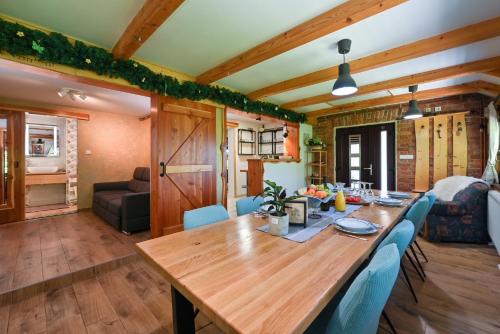 a dining room with a wooden table and blue chairs at Zagorska Bajka in Krapina