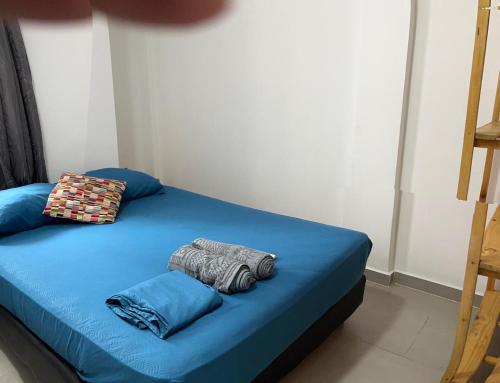 a bed with blue sheets and pillows in a room at Habitación cerca de la playa 201 in Cartagena de Indias