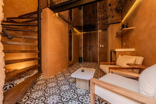 a room with a staircase and a couch and a table at Hotel Villa Alta Guest House in Cartagena de Indias