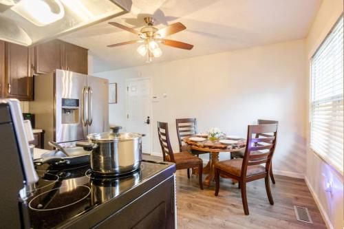 a kitchen and dining room with a dining table at Private Ranch - Entire Home - 3 Bed Room - Hot Tub - King Bed - Fenced Yard - Pets & Kids Welcome - Game Shed - Free WiFi in Columbus