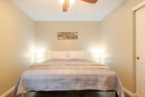 a bedroom with a bed with a blanket at Private Ranch - Entire Home - 3 Bed Room - Hot Tub - King Bed - Fenced Yard - Pets & Kids Welcome - Game Shed - Free WiFi in Columbus