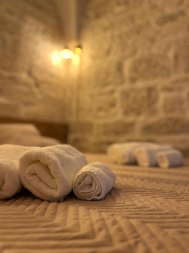 a stack of towels laying on a bed at L'Arpa Bianca in Ceglie Messapica