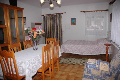 a bedroom with two beds and a vase of flowers at Casa Baptista I in Marinha Grande