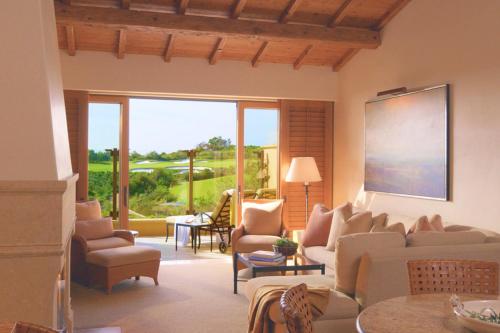 a living room with a couch and chairs at The Resort at Pelican Hill in Crystal Cove