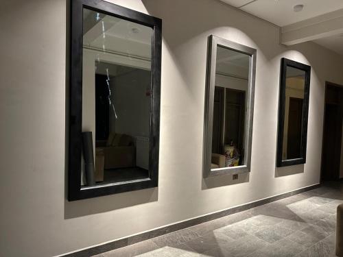 a room with three mirrors on a wall at Coscaña Uyuni Hotel by Toloma in Uyuni