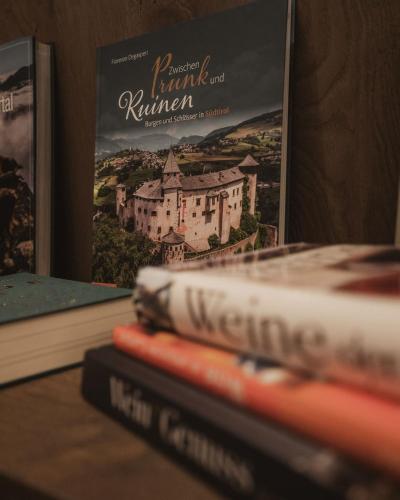 a stack of books sitting on top of a table at Hotel Bad Fallenbach in San Leonardo in Passiria
