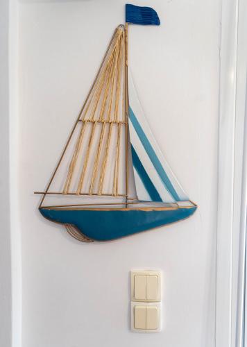 a model of a sailboat hanging on a wall at Cookoo Villas in Kriopigi