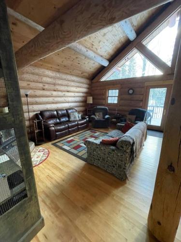 a living room with a couch and chairs in a cabin at Rustic Lake Michigamme Hideaway in Three Lakes