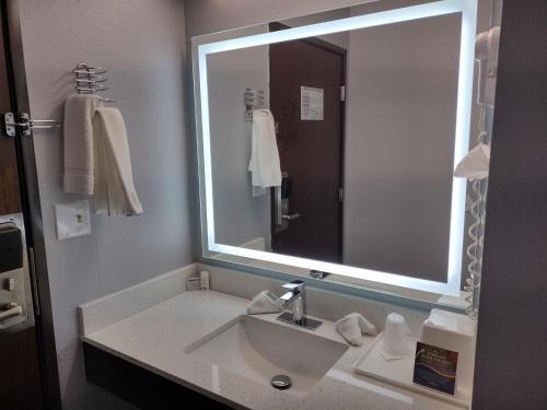 a bathroom with a sink and a large mirror at Baymont by Wyndham Duluth Spirit Mountain in Duluth