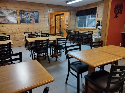 a dining room with wooden tables and chairs at Baymont by Wyndham Duluth Spirit Mountain in Duluth