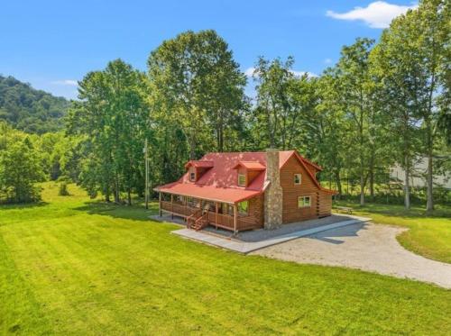 a small house with a red roof in a field at Biggie Cabin in Stanton