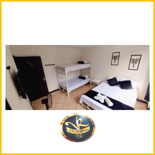 a hotel room with a bed and a desk at HOTEL VILLA ROSa in Medellín