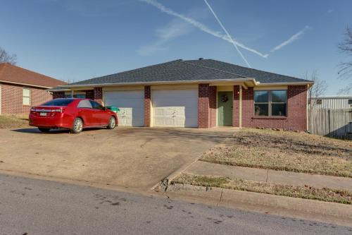 a red car parked in front of a house at Centrally located in NWA Walk to Wrights BBQ! in Fayetteville