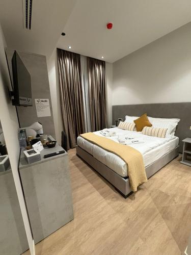 a bedroom with a large bed and a flat screen tv at LaBienbi' in Cosenza