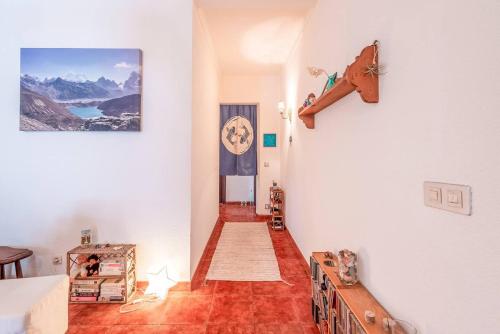 a room with a hallway with a clock on the wall at Casa da Rita in Cascais