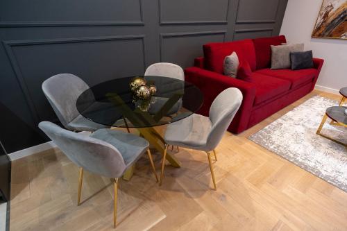 a living room with a glass table and chairs at Tara Centar in Trebinje