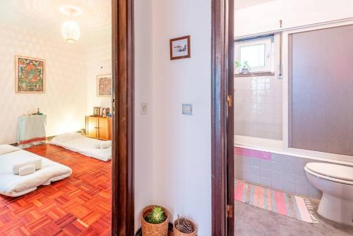 a bathroom with a toilet and a sink in a room at Casa da Rita in Cascais