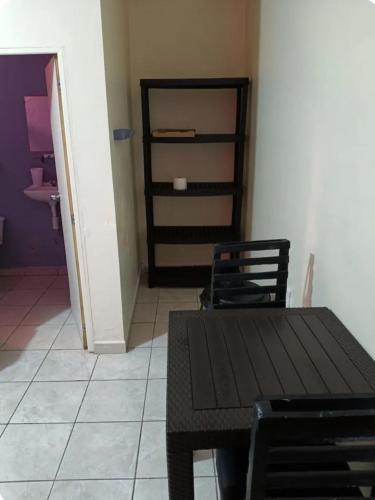 a dining room with a table and two chairs at Cómodos cuartos para tu economia in Mazatlán