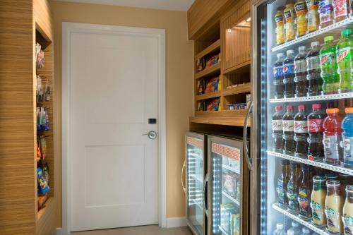 a refrigerator filled with lots of bottles of soda at TownePlace Suites Boone in Boone