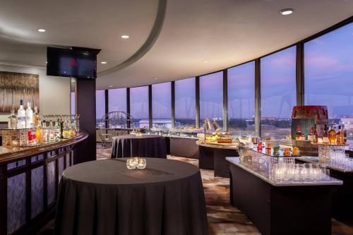 a restaurant with a bar with a view of the city at Tampa Airport Marriott in Tampa