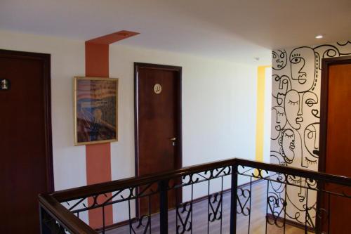 a room with a staircase with a railing and a door at Hostería Los Gnomos in El Calafate
