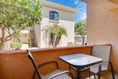a table and chairs on a balcony with a building at Communal Pool Sunny First-Floor Condo in Phoenix in Phoenix