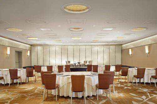 a conference room with tables and chairs and a podium at The Ritz-Carlton, Vienna in Vienna