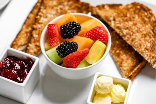 a white bowl filled with fruit and other food at The Westin Oaks Houston at the Galleria in Houston