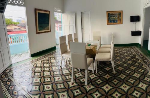 a dining room with a table and chairs on a tile floor at Casa Turbay in Cartagena de Indias