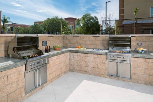 an outdoor kitchen with two stoves on a patio at Residence Inn by Marriott Ontario Rancho Cucamonga in Rancho Cucamonga