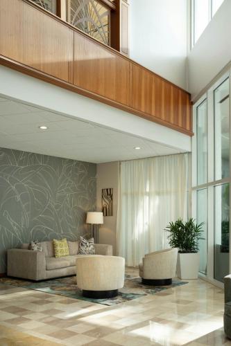 a living room with a couch and two chairs at Clearwater Beach Marriott Resort on Sand Key in Clearwater Beach