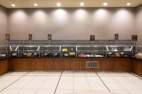 a restaurant kitchen with a counter with food at SpringHill Suites by Marriott Las Vegas Convention Center in Las Vegas