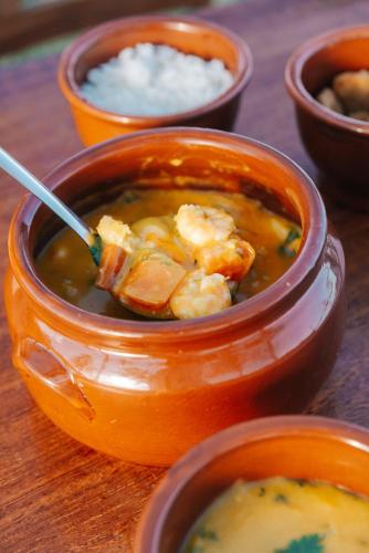 a bowl of soup with shrimp and rice on a table at Palawan Pousada & Bistrô in Nísia Floresta