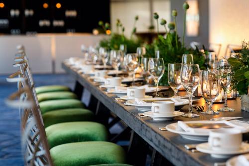 a long table with plates and wine glasses on it at Minneapolis Marriott City Center in Minneapolis