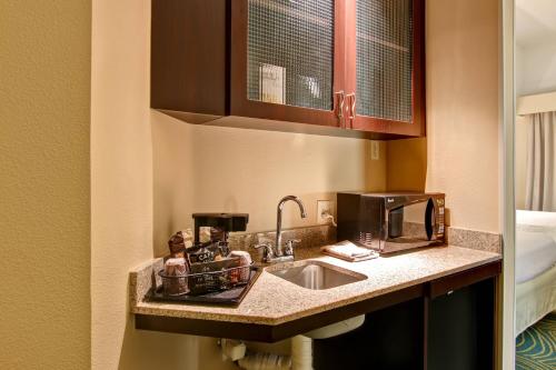 a kitchen counter with a sink and a coffee maker at SpringHill Suites Fresno in Fresno
