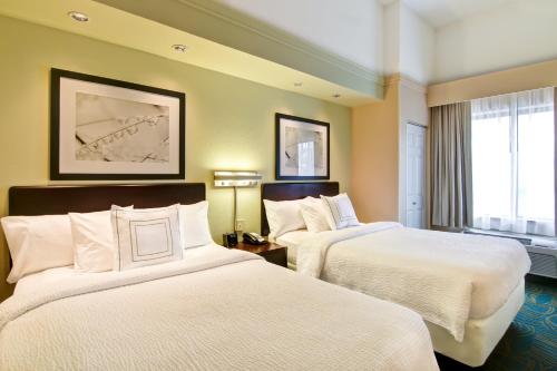 a hotel room with two beds and a window at SpringHill Suites Fresno in Fresno