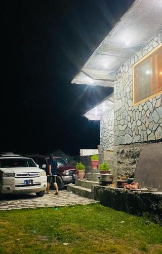 a man walking in front of a house at night at Astore Oasis Resort Gorikote in Kine Dās